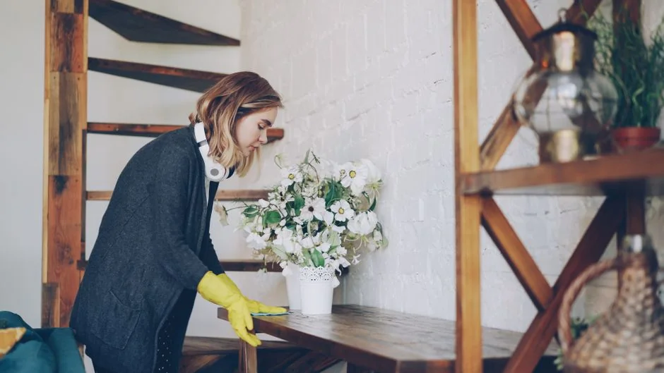 A couple collaboratively lifting a couch while moving into a new apartment.